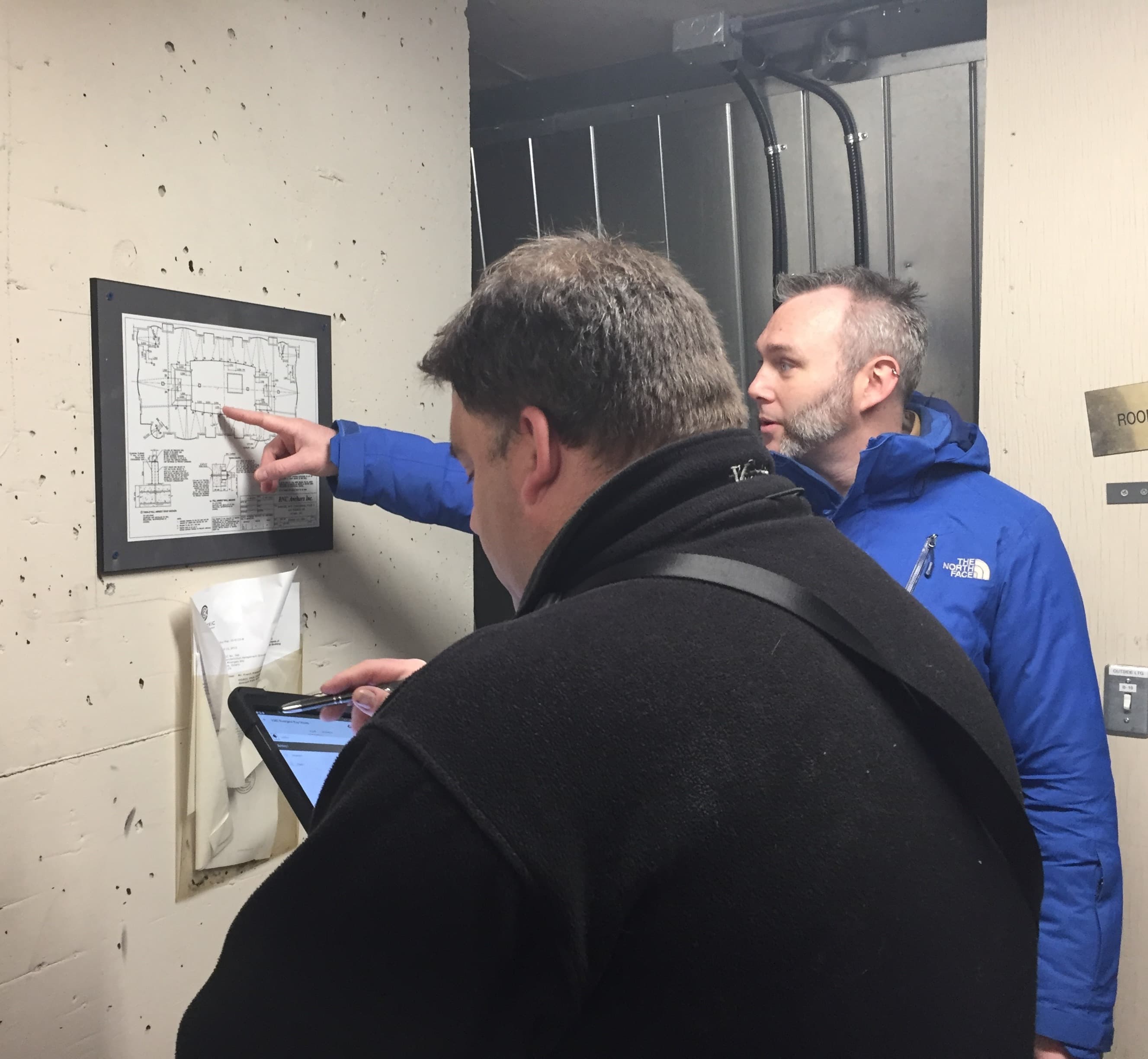 Existing floor plans on the walls reveal clues