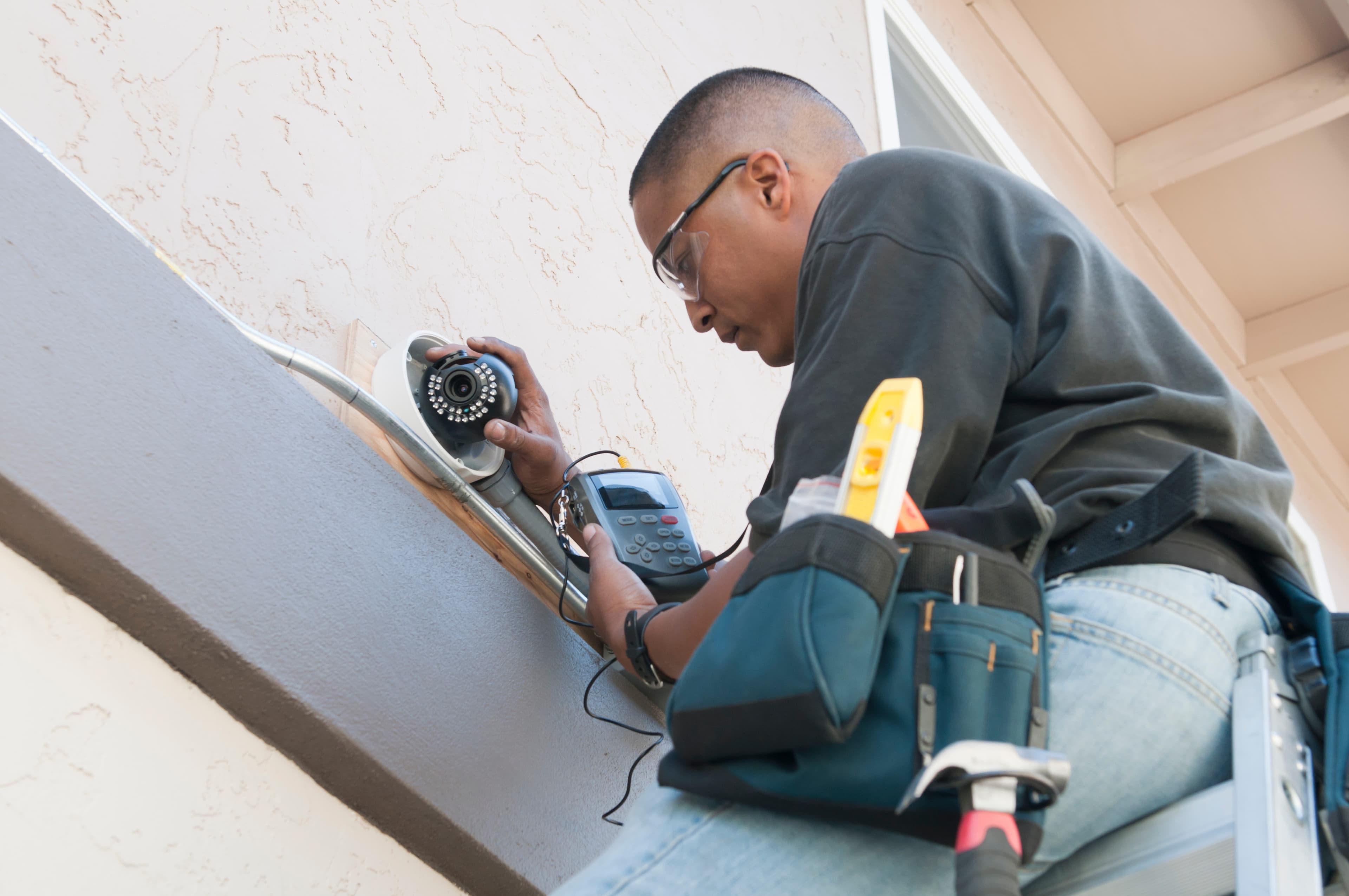 A technician working under time pressure on a job site installation